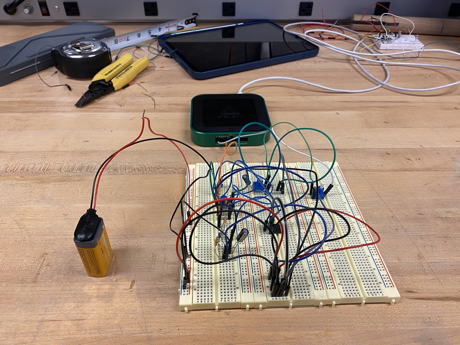 The overdrive pedal circuit built on a breadboard, wired to a 9V battery on the workbench