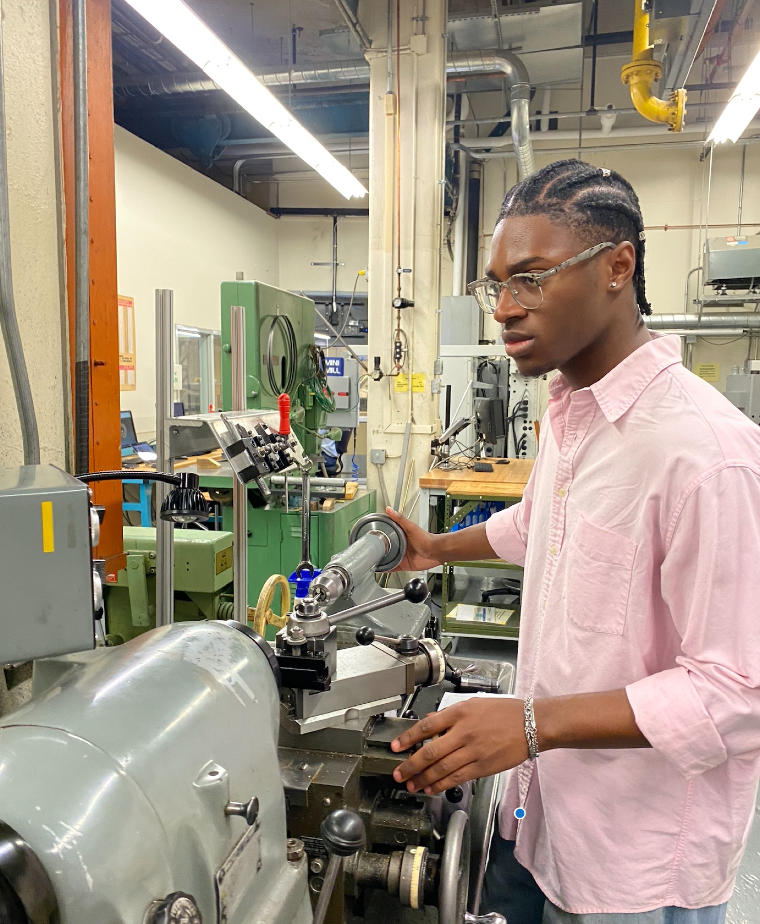 Turning a component on the manual lathe in the machine shop